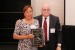 Dr. Nagib Callaos, General Chair, giving Dr. María Dolores García Perea a plaque "Por su Excelente Ponencia Plenaria."